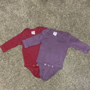 Two Kate Quinn Newborn bodysuits